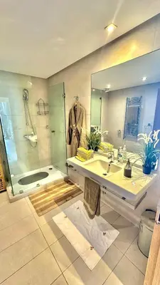 a bathroom with a sink and a shower and a mirror at Ocean View 2 Bedroom Apartment in Casablanca