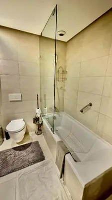 a bathroom with a tub and a toilet and a sink at Ocean View 2 Bedroom Apartment in Casablanca