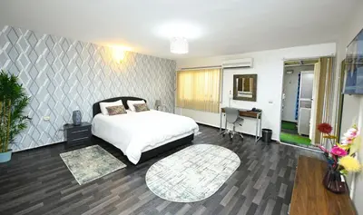 a bedroom with a bed and a desk in it at Hamouda Tabina in Rabat