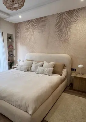 a bedroom with a large white bed with a wall at Luxury apartment with sea view and 2 pools Sablettes in Mohammedia
