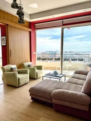 a living room with a couch and a large window at Terrace & View of Casablanca Port in Casablanca