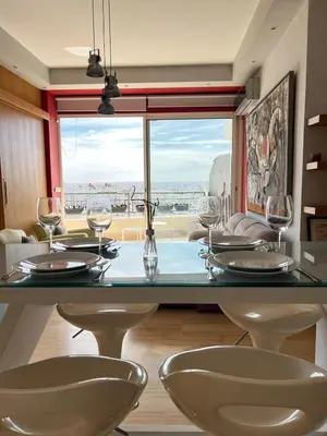 a dining room with a table with wine glasses at Terrace & View of Casablanca Port in Casablanca