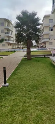 a palm tree in the middle of a park at Résidence Sable Dor in Mohammedia