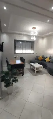 a living room with a couch and a table at Résidence Sable Dor in Mohammedia