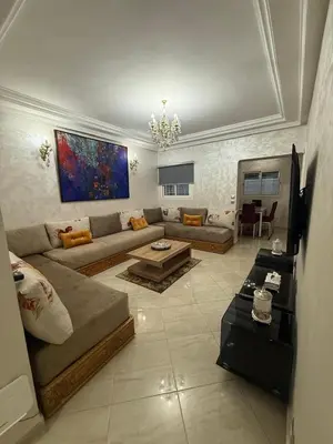 a living room with a couch and a table at Pavilion à la corniche de mohammedia proche plage & centre-ville in Mohammedia