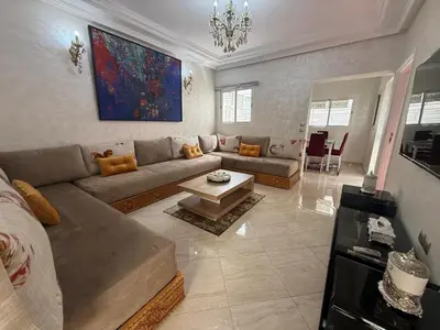 a living room with a couch and a table at Pavilion à la corniche de mohammedia proche plage & centre-ville in Mohammedia