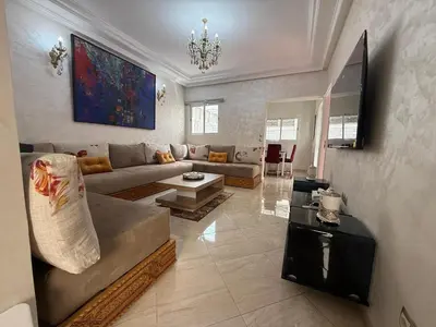 a living room with a couch and a table at Pavilion à la corniche de mohammedia proche plage & centre-ville in Mohammedia