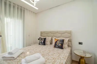a bedroom with a large bed with towels on it at Joli Studio au Cœur de CFC En Face Aeria Mall in Casablanca