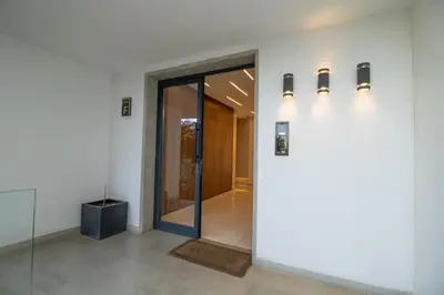 a hallway with a glass door in a building at Joli Studio au Cœur de CFC En Face Aeria Mall in Casablanca