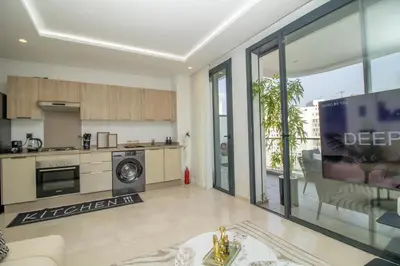 a large kitchen and living room with a large window at Joli Studio au Cœur de CFC En Face Aeria Mall in Casablanca