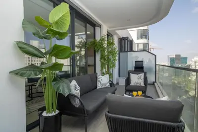 a living room with a couch and some plants on a balcony at Joli Studio au Cœur de CFC En Face Aeria Mall in Casablanca