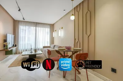 a living room with a table and a couch at Studio moderne in the Heart of Maarif Casablanca in Casablanca