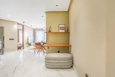 a living room with a table and a stool at Studio moderne in the Heart of Maarif Casablanca in Casablanca