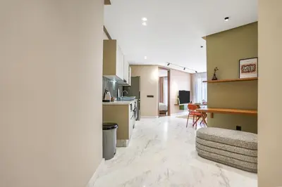 a kitchen and living room with a couch and a table at Studio moderne in the Heart of Maarif Casablanca in Casablanca