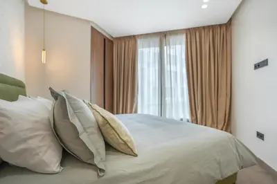 a bedroom with a bed with pillows and a window at Studio moderne in the Heart of Maarif Casablanca in Casablanca