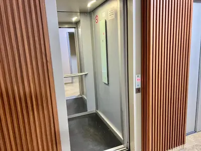 a elevator with a glass door in a building at Urban Comfort Casablanca - 3BR Family Apartment in Casablanca