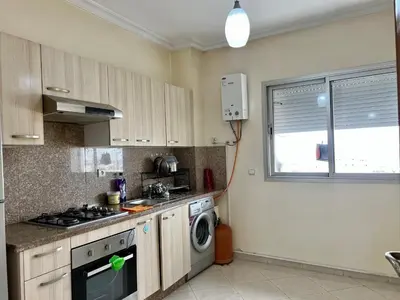 a kitchen with a stove and a washing machine at Urban Comfort Casablanca - 3BR Family Apartment in Casablanca