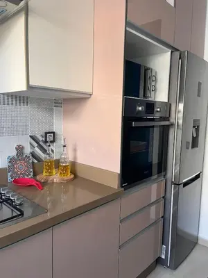 a kitchen with a refrigerator and a counter top at The Blue Beach apartment- Residence Skhirat Beach2 in Skhirat