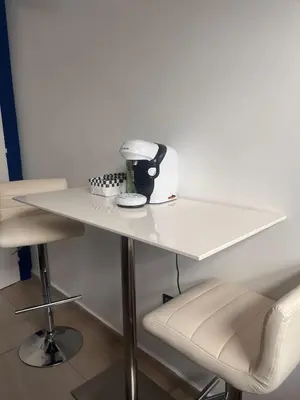 a white table with a mixer and two chairs at The Blue Beach apartment- Residence Skhirat Beach2 in Skhirat