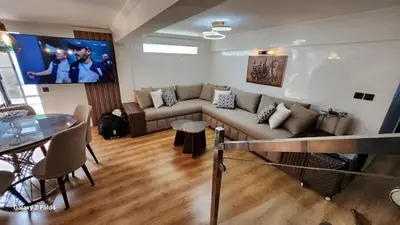 a living room with a couch and a table at Apartment in Harhoura in El Harhoura