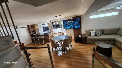a living room with a table and a couch at Apartment in Harhoura in El Harhoura