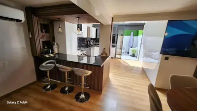 a kitchen with two stools and a counter top at Apartment in Harhoura in El Harhoura