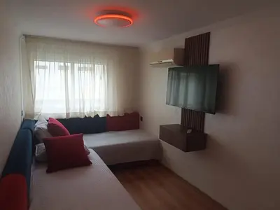 a small room with a bed and a television at Apartment in Harhoura in El Harhoura