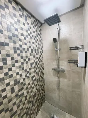 a bathroom with a shower with a checkerboard wall at Votre Cocon Moderne - Central & tout confort in Casablanca