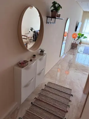a hallway with a circular mirror and a rug at Shems Bouznika Residence Central & Cozy 2 Bedroom Apartment with Pool Bouznika in Bouznika