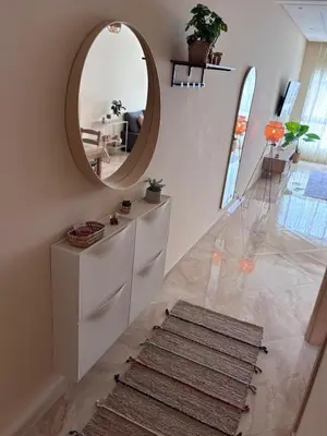 a hallway with a circular mirror and a rug at Shems Bouznika Residence Central & Cozy 2 Bedroom Apartment with Pool Bouznika in Bouznika