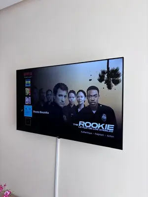 a flat screen tv hanging on a wall at Shems Bouznika Residence Central & Cozy 2 Bedroom Apartment with Pool Bouznika in Bouznika