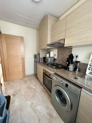 a kitchen with a washing machine in a kitchen at Shems Bouznika Residence Central & Cozy 2 Bedroom Apartment with Pool Bouznika in Bouznika