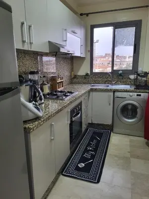 a kitchen with a washer and a rug on the floor at Lovely rental apartment with parking in premises, in Casablanca