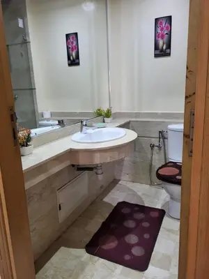 a bathroom with a sink and a toilet and a mirror at Lovely rental apartment with parking in premises, in Casablanca