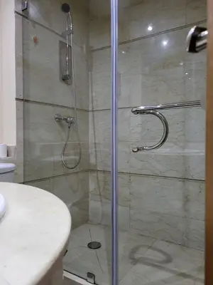 a shower with a glass door in a bathroom at Lovely rental apartment with parking in premises, in Casablanca