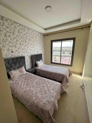 a bedroom with two beds and a window at Lovely rental apartment with parking in premises, in Casablanca