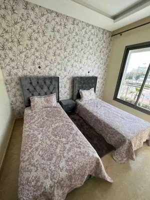 a bedroom with two beds and a window at Lovely rental apartment with parking in premises, in Casablanca