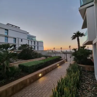 a walkway in front of a building with the beach at Appartement front mer à Casablanca in Casablanca