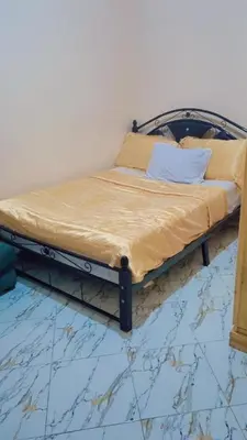 a bed with a metal frame in a room at Chez binette in Casablanca