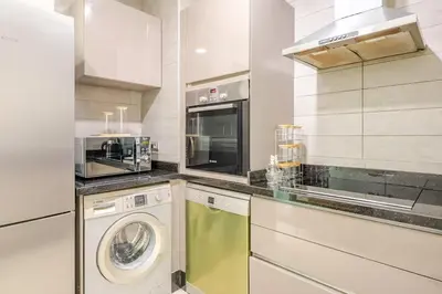 a kitchen with a washing machine and a washer at Harcay CFC in Casablanca