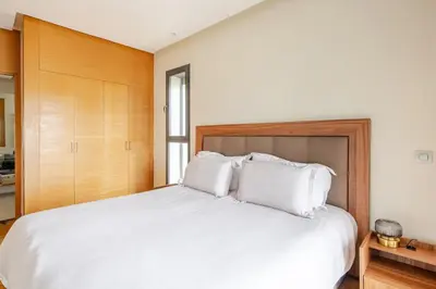 a bedroom with a large bed with white pillows at Harcay CFC in Casablanca