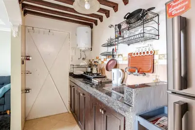 a kitchen with a counter top and a refrigerator at Layover Guest House - Studio Rabat City Center - 4th Floor in Rabat