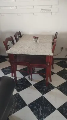 a table with chairs and a bowl on top of it at Appartement dar bouaaza tamaris in Tamaris