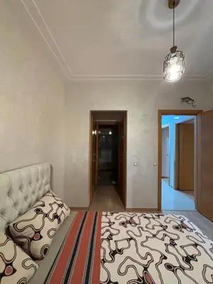 a large bedroom with a bed and a hallway at Appartement familiale in Tamaris