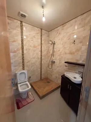 a bathroom with a toilet and a sink at Appartement familiale in Tamaris