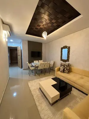 a living room with a couch and a table at Appartement familiale in Tamaris