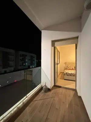 a view of a bedroom with a bed on a balcony at Appartement familiale in Tamaris