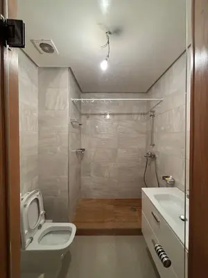 a bathroom with a toilet and a sink at Appartement familiale in Tamaris