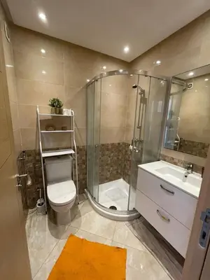 a bathroom with a shower and a toilet and a sink at residence ramo flores in Bir Jedíd Saint-Hubert