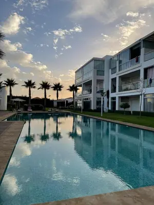 a large swimming pool in front of a building at residence ramo flores in Bir Jedíd Saint-Hubert